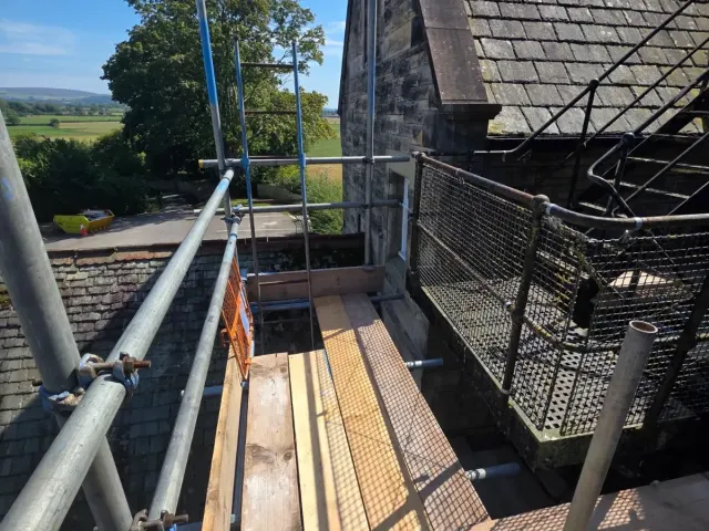 Boarded scaffold lift on a stone barn conversion