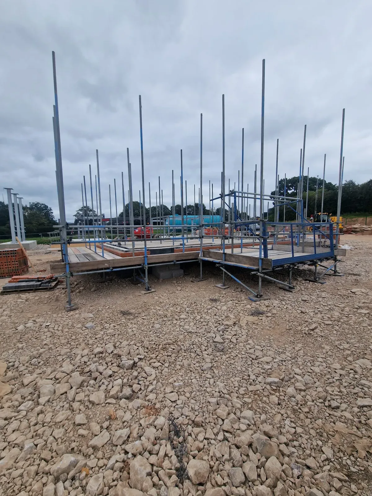 Bricklayers scaffold platforms on a new build plot