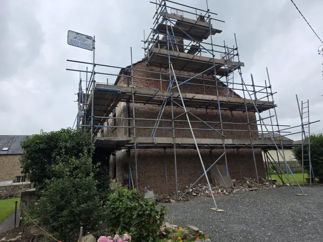 Full scaffold wrap on a brick farmhouse restoration